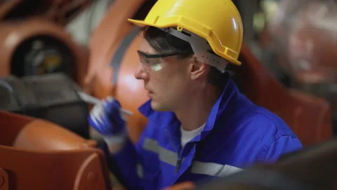 Male engineer checking and fixing robot arm. 스톡 동영상 239508555