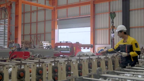 Male engineer checking machine for readiness before starting production. Stock Footage 250246021