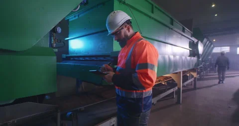 Male engineer checking valve on industrial machinery Stock Footage 147931586