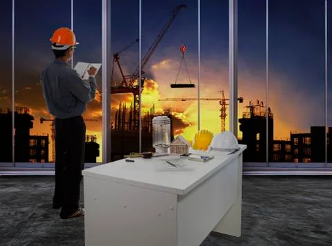 Male engineer checking work flow in building construction site against beauti 写真素材