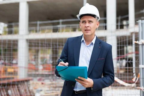 Male engineer checking work process in construction site Stock Photos