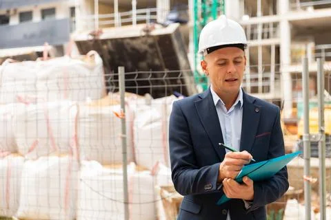 Male engineer checking work process in construction site Stock Photos