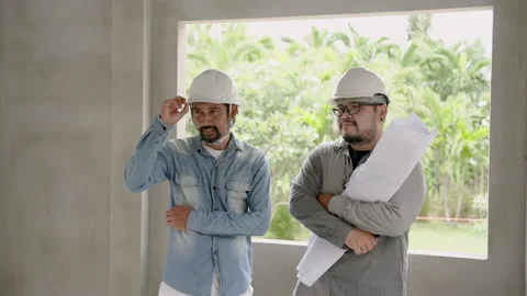 Male engineer construction supervisor and young Asian architect Standing Stock Footage 257439563