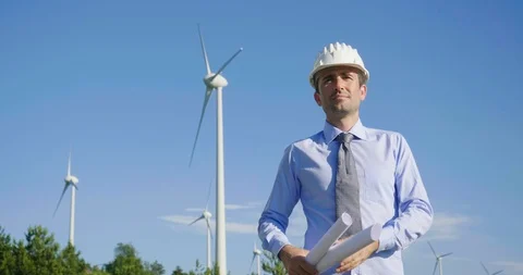 A male engineer is controlling a functioning of wind turbines. 動画素材 115124564