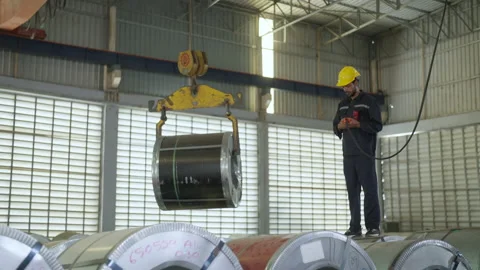 Male engineer controlling machine at metal sheet factory. Stock Footage 229365749