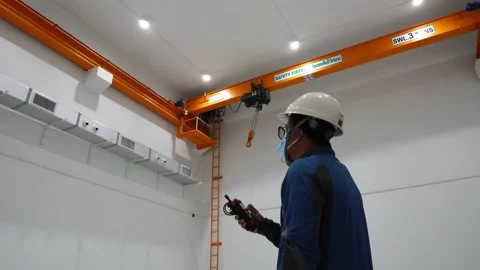 A male engineer is controlling the operation of the crane Stock Footage 158172599