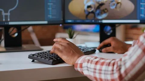 Male engineer designs 3D prototypes in a modern industrial interface Stock Photos