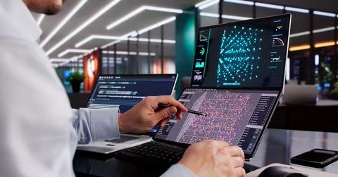 Male Engineer Developing AI Technology Using Multiple Computer Screens At Off Stock Photos