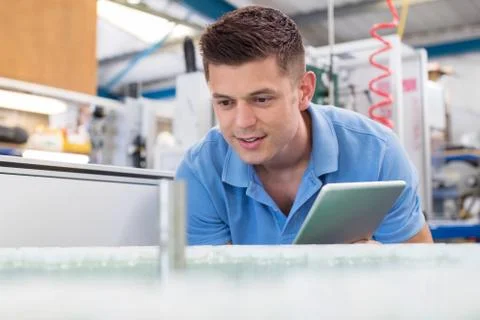 Male Engineer With Digital Tablet Working In Bottle Capping Factory Stock Photos