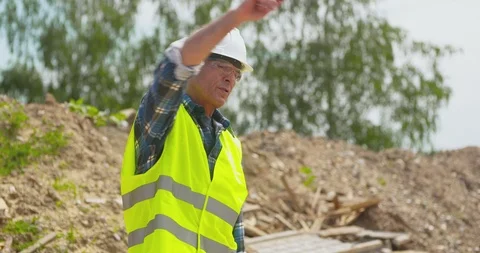 Male Engineer Explaining While Holding Blueprint Stock Footage 106484450