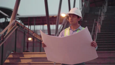 Male engineer with hard hat looking and checking progress of Sky Train project. Stock Footage 153043038