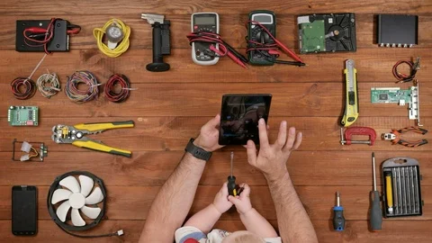 Male engineer with his son looking photo on tablet plate. Boy holding a Stock Footage 72423209