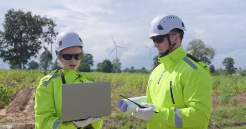 Male engineer holding tablet analyzing wind turbine system maintenance Stock Footage 335218560