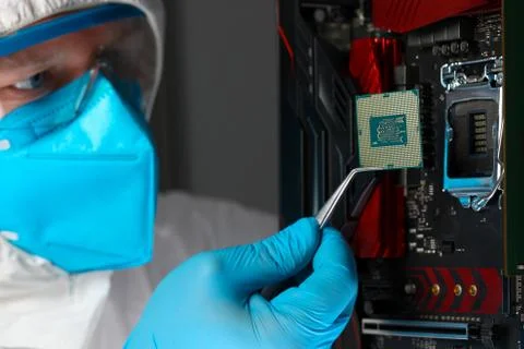 Male engineer install microprocessor in fast computer Stock Photos