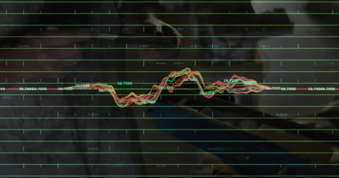 Male engineer interacting with touchscreen in tech lab, displaying data grid 動画素材 307449072