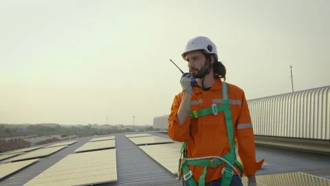 Male engineer maintaining solar cell panels on building rooftop. Stock Footage 229158117