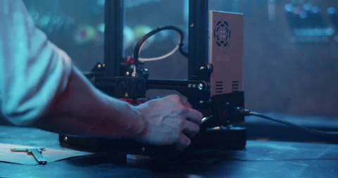 Male engineer making prototype with 3D printer in dark workshop Stock Footage 259390895
