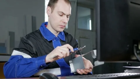 Male engineer measures the item and enter the data into a computer program CNC Stock Footage 71643752
