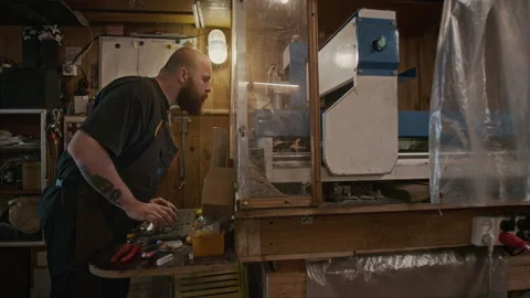 Male Engineer Operating Computerized High Precision Cutting Lathe Stock Footage 287527096