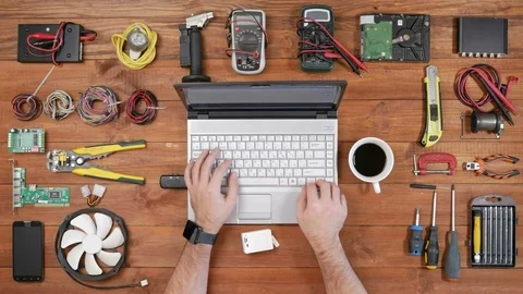 Male engineer programmer copies files from a flash card action camera on a Stock Footage 72417107