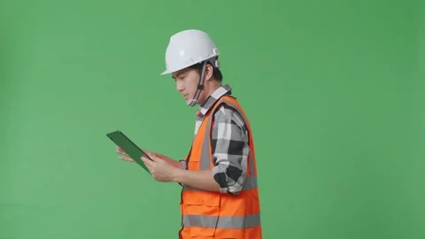 Male Engineer With Safety Helmet Using Tablet While Walking In The Green Screen Stock Footage 247997335
