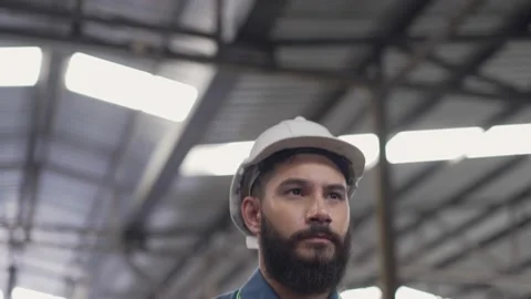 Male engineer in safety uniform walking in the factory Stock Footage 194415417