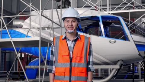 Male Engineer Smiling and Inspecting Helicopter Stock Footage 312126419