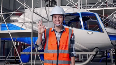 Male Engineer Smiling And Showing Okay and Inspecting Helicopter Stock Footage 312126496