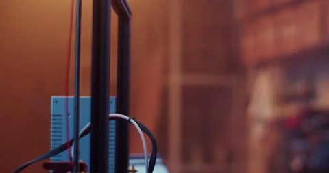 Male engineer using computer while creating 3D model with printer Stock Footage 259391318