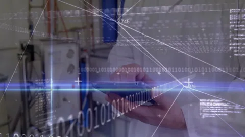 Male engineer using handheld device in industrial lab, showing real-time data Stock Footage 307563693