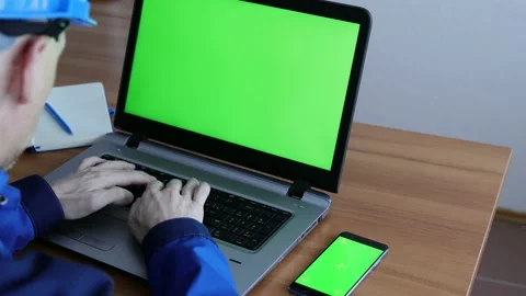 Male Engineer using Laptop Computer with Green Screen inside office. Stock Footage 168578794