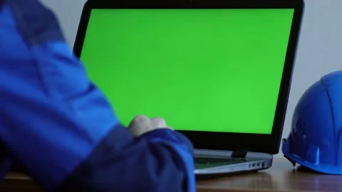 Male Engineer using Laptop Computer with Green Screen inside office. Stock Footage 168578813