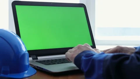 Male Engineer using Laptop Computer with Green Screen inside office. Stock Footage 169385006