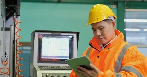 Male engineer using tablet for work at production line. Video stock 118287919