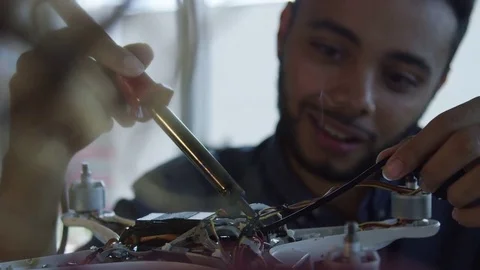 Male Engineer Wiring A Robot In A Tech Startup Видео 82390394