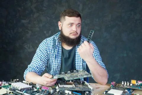 Male engineer work with broken computer components Stock Photos