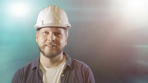 A male engineer worker in a construction helmet smiles portrait Stock Footage 211130165