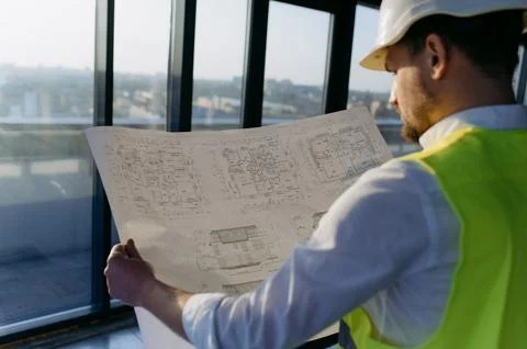 Male engineer working on an architectural project at a construction site in.. Stock Photos