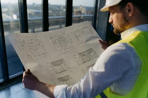 Male engineer working on an architectural project at a construction site in.. Stock Photos