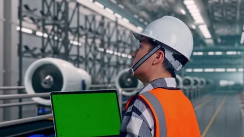 Male Engineer Working On A Green Screen Smartphone, Aircraft Engine Factory Video stock 314590929