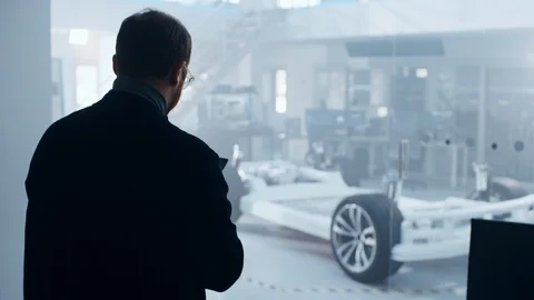 Male Engineer is Working in a High Tech Development Facility Holding a Tablet Stock Footage 106758357