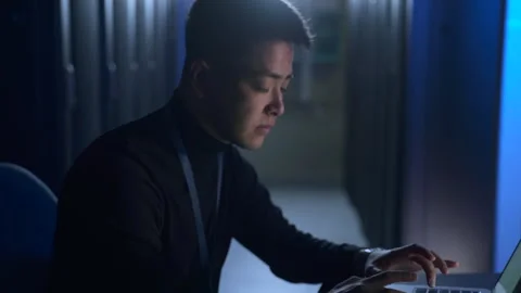 Male engineer working on IT project and sitting at table with laptop on render Stock Footage 163816611