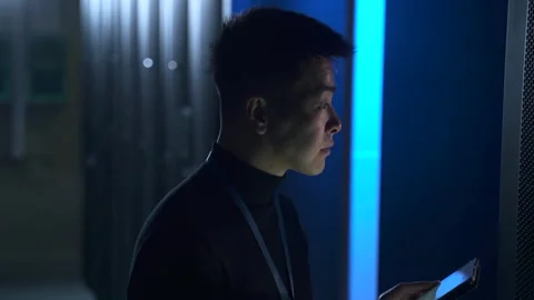 Male engineer working with tablet and checking equipment while standing in Stock Footage 165586357