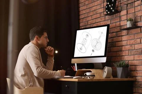 Male engineer working with technical drawing on computer in office Foto stock