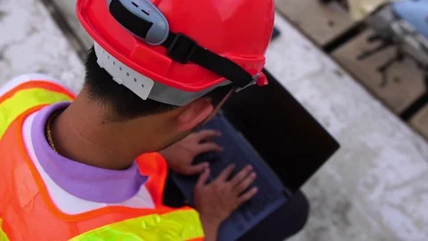 Male engineers are drinking coffee while working outside Video stock 107379649