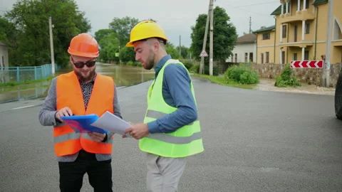 Male engineers solve flood problem. Devastation wrought after massive disasters 스톡 동영상 135385347