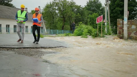 Male engineers solve flood problem. Devastation wrought after massive disasters Video stock 135386669