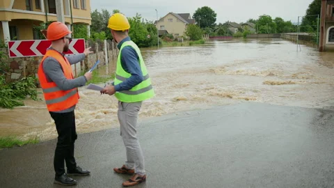 Male engineers solve flood problem. Devastation wrought after massive disasters Stock-Footage 135431008