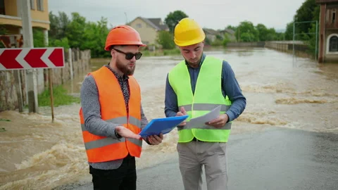 Male engineers solve flood problem. Devastation wrought after massive disasters Stock-Footage 135615815