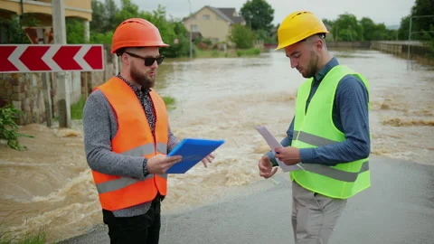 Male engineers solve flood problem. Devastation wrought after massive disasters Video stock 137647138